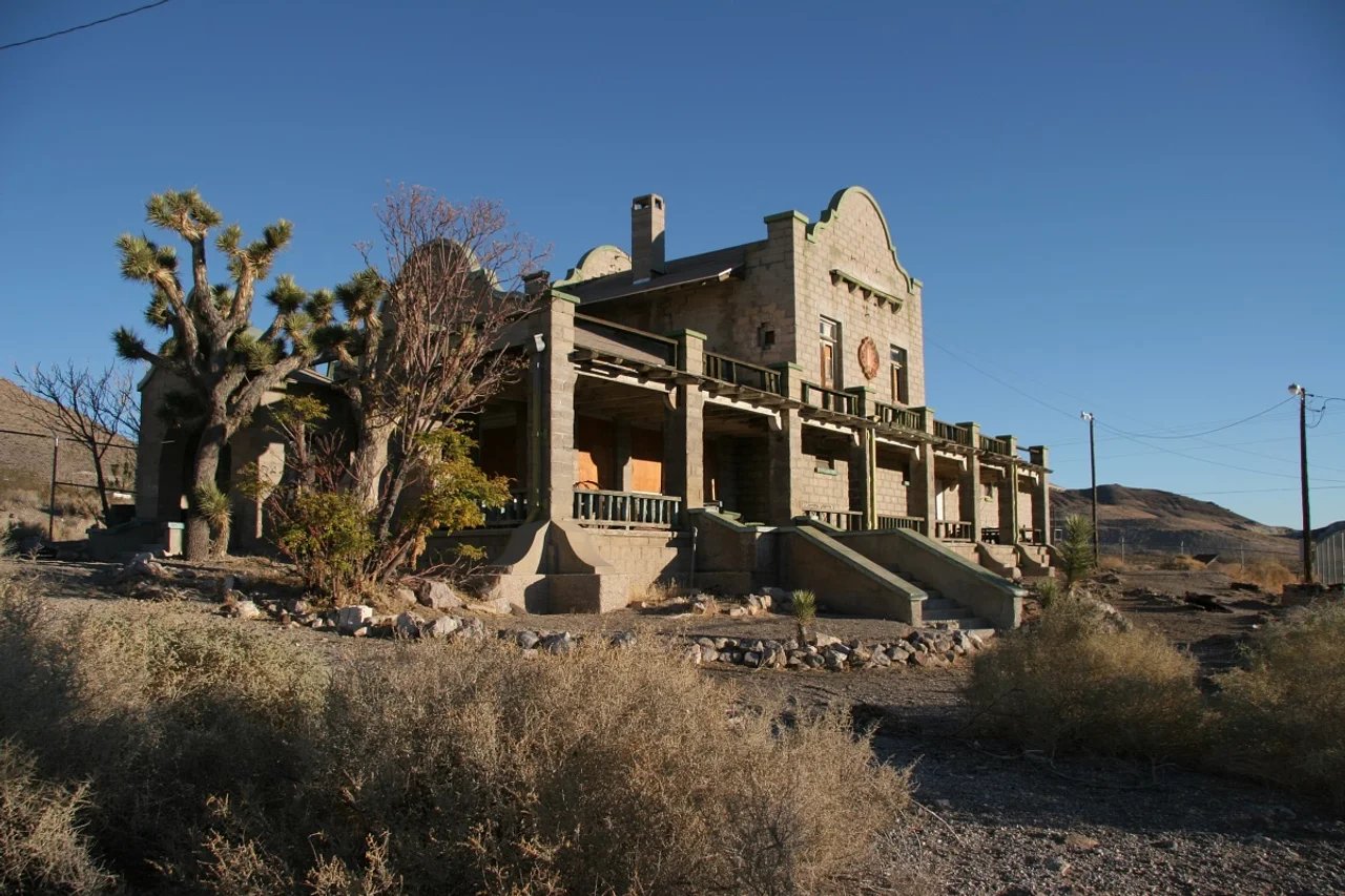 The Las Vegas and Tonopah Railroad depot in Rhyolite, Nevada, framed by Joshua trees and desert